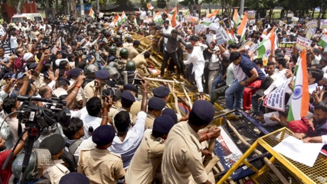 Police personnel try to evict members of the All Bihar Students' Union during their march against the state government over issues including paper leaks, unemployment and irregularities in recruitment, in Patna, Bihar. Pic/PTI